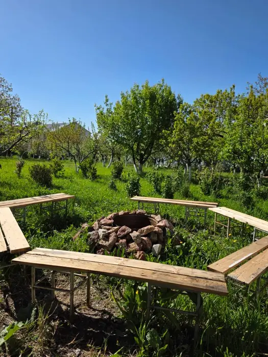 Stone fire pit surrounded by four wooden benches