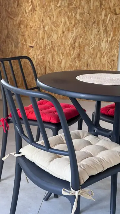 Close-up of the terrace chairs with red and cream cushions