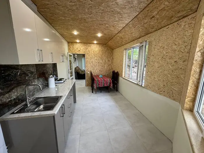The shared kitchen looking down the room towards the dining table