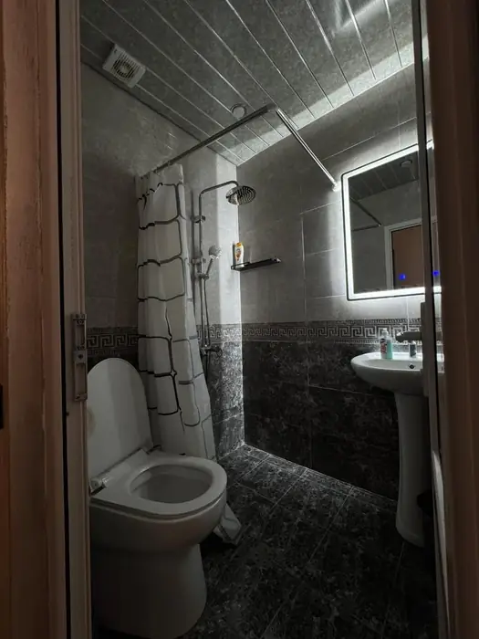 The room's own bathroom with rain shower and extractor fan