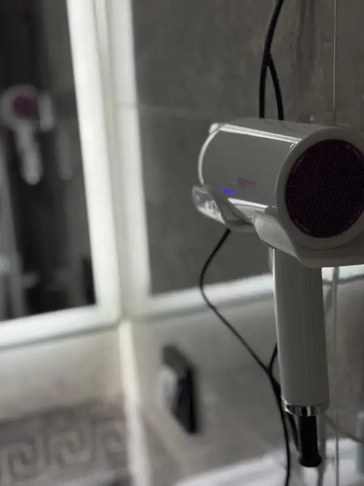 Hairdryer mounted on the bathroom wall